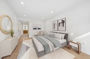 Chicago apartment for rent - A bedroom with a large bed and a mirror on the wall.