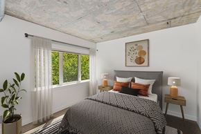 Seattle apartment for rent - a bedroom with a bed and a large window