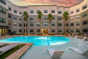 Houston apartment for rent - a large swimming pool in front of an apartment building