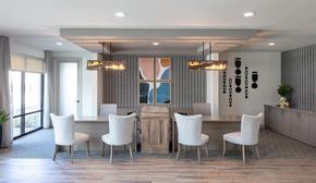 Houston apartment for rent - a dining room with white chairs and a wooden table