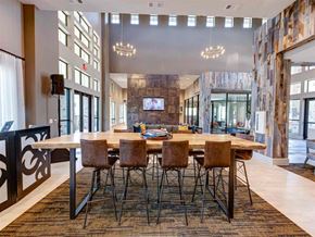 New Caney apartment for rent - Large wooden dining table with chairs at The Pointe at Valley Ranch Town Center, New Caney