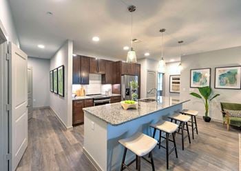 Kitchen with long island with stools