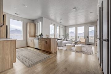 Murray apartment for rent - A modern kitchen with wooden cabinets and a large window overlooking the mountains.
