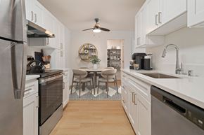 Bellevue apartment for rent - A kitchen with a table and chairs in the middle.