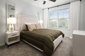 Brentwood apartment for rent - a bedroom with a bed and a ceiling fan