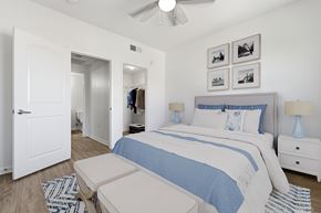 Chula Vista apartment for rent - A bedroom with a bed, nightstand, and a ceiling fan.
