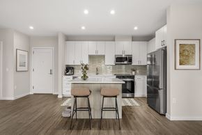 Marlborough apartment for rent - A modern kitchen with white cabinets and a center island.