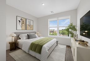 Marlborough apartment for rent - A bedroom with a large bed and a window overlooking a green landscape.