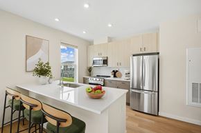 Londonderry apartment for rent - A kitchen with a white counter top and a stainless steel refrigerator.