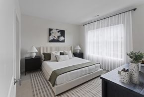 Londonderry apartment for rent - A bedroom with a large bed and a painting above it.