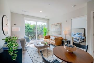 Wilton townhouse for rent - A living room with a wooden table and a couch.