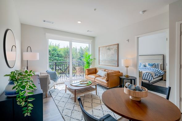 Wilton apartment for rent - a living room with a couch and a table and a balcony