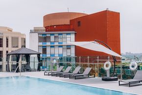 Glendale apartment for rent - A pool area with a red building in the background.