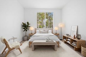 Chula Vista apartment for rent - A bedroom with a large bed, a chair, and a plant.