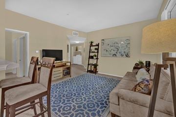 Chula Vista apartment for rent - A living room with a blue patterned carpet and a brown couch.