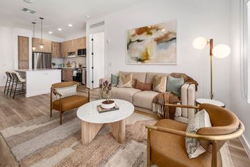 Mesa apartment for rent - A living room with a brown chair and a white coffee table.