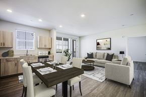Brentwood apartment for rent - A modern dining room with a wooden table and white chairs.