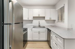 Casa Grande apartment for rent - A kitchen with white cabinets and a stainless steel refrigerator.