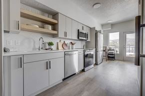 Salt Lake City apartment for rent - an open kitchen with white cabinets and stainless steel appliances