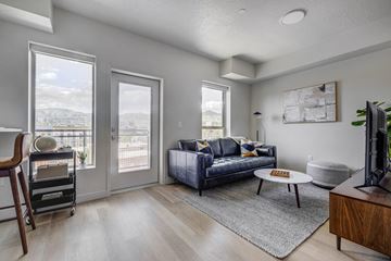 Salt Lake City apartment for rent - an open living room with a couch and a tv
