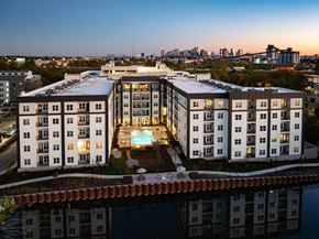 Nashville apartment for rent - A modern apartment building with a pool in the middle of it.
