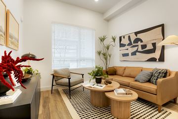 Salt Lake City apartment for rent - A living room with a couch, chair, and a table with a vase on it.