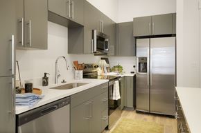 Salt Lake City apartment for rent - A modern kitchen with stainless steel appliances and grey cabinets.