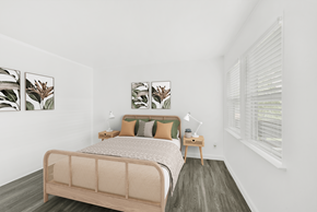 San Jose apartment for rent - A bedroom with a bed, nightstands, and pictures on the wall.