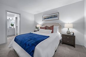 Phoenix apartment for rent - A bedroom with a large bed and a painting on the wall.