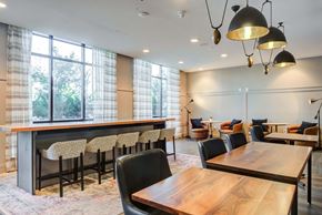 Herndon apartment for rent - a room with a long wooden table and chairs and a large window