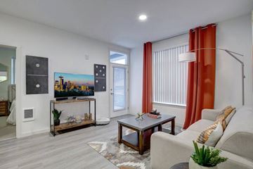 Lacey apartment for rent - A living room with a grey couch, a coffee table, and a painting on the wall.