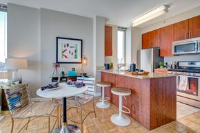 New York apartment for rent - a kitchen and living room with a counter and stools