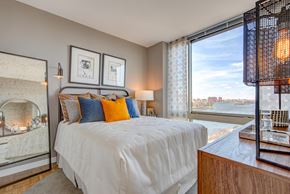 New York apartment for rent - a bedroom with a bed and a view of the water