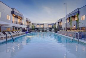 West Valley apartment for rent - A large indoor swimming pool with lounge chairs and umbrellas.