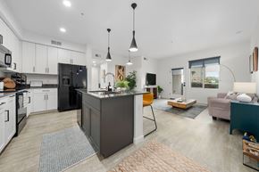 Mesa apartment for rent - A modern kitchen with a black refrigerator and white cabinets.