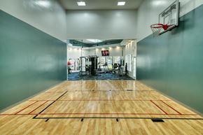 Gilbert apartment for rent - the court in the gym with a basketball hoop and a scoreboard