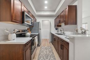 Flagstaff apartment for rent - A kitchen with brown cabinets and a white countertop.