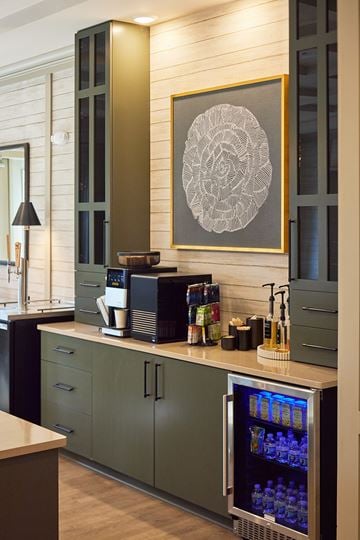 Wilmington apartment for rent - A modern kitchen with a green cabinet and a fridge with a glass door.