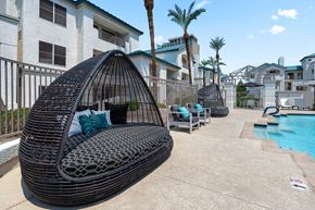 Phoenix apartment for rent - a swing chair next to a swimming pool