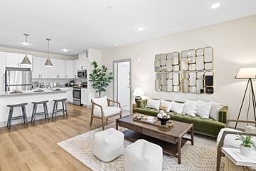 North Charleston apartment for rent - A modern living room with a green couch and a wooden coffee table.