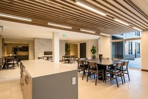 Arvada apartment for rent - A modern dining area with a long table and chairs.
