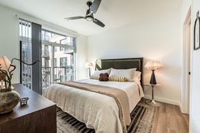 Arvada apartment for rent - A bedroom with a large bed and a ceiling fan.
