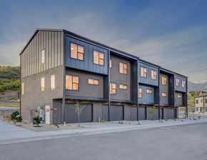 Draper apartment for rent - A modern building with a black facade and multiple windows.