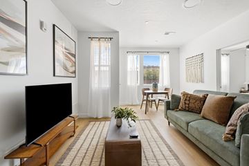 Cedar City apartment for rent - A living room with a green couch and a wooden coffee table.