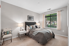 Washington apartment for rent - A bedroom with a bed, nightstand, chair, and window.