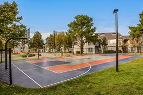 Albuquerque apartment for rent - a basketball court with trees and apartments in the background