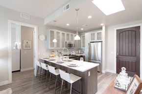 Salt Lake City apartment for rent - A modern kitchen with a long table and chairs.