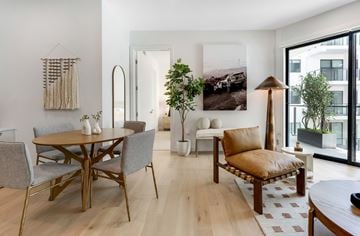 Los Angeles apartment for rent - A modern living room with a wooden table and grey chairs.