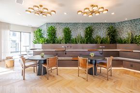 Orlando apartment for rent - A dining area with a green wallpaper and wooden floors.