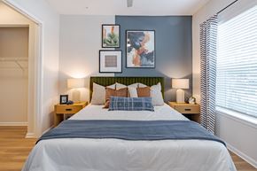 Orlando apartment for rent - A bedroom with a large bed and a green headboard.